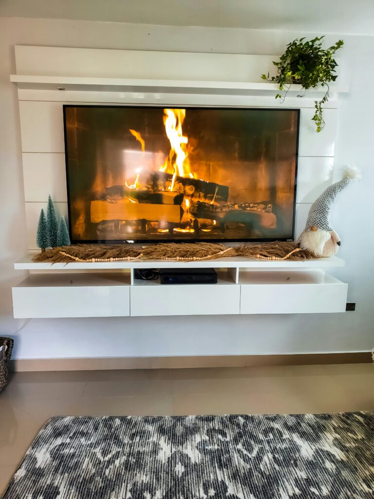 Warm and inviting indoor fireplace with festive holiday decorations.